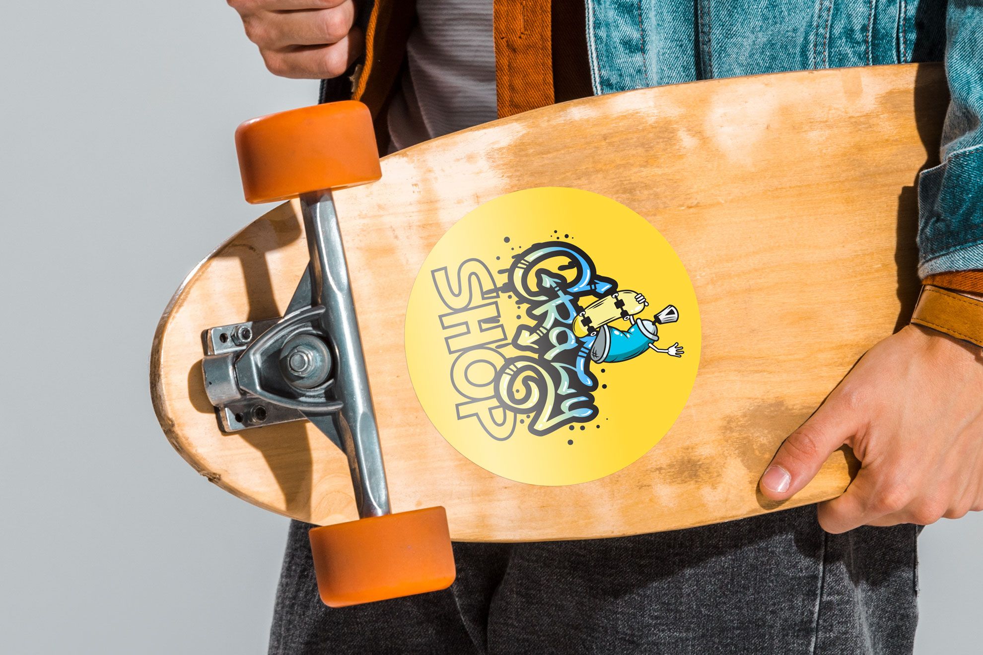 Bright yellow round sticker on wooden skateboard Vibrant yellow round sticker with custom artwork applied to a wooden skateboard. These durable custom round stickers are ideal for personalizing skateboards, laptops, luggage, and branded merchandise. Design and print your own premium quality stickers online with our affordable printing service.