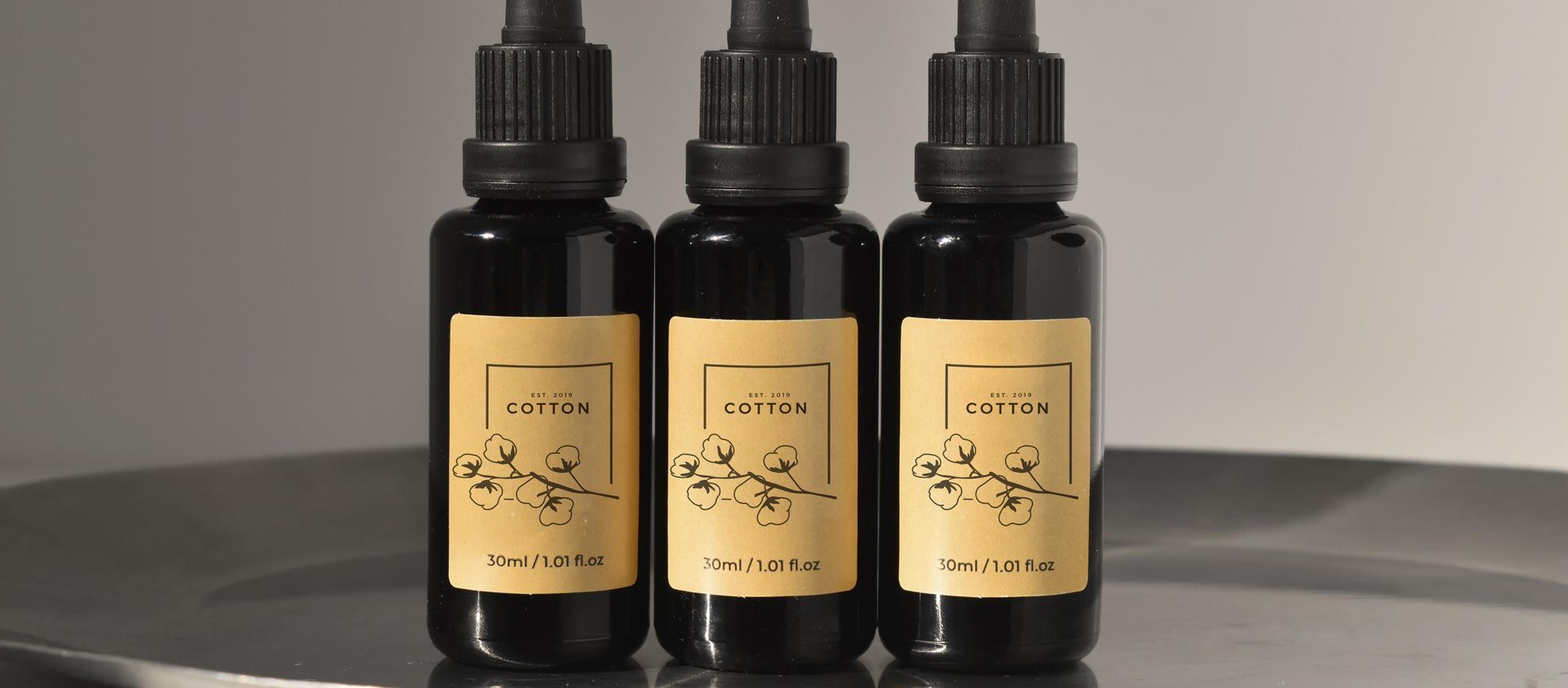 Showcase your brand identity with custom printed labels on premium packaging. These elegant gold labels on black bottles demonstrate the professional finish and visual impact that personalized label printing delivers for cosmetic and specialty product lines. Elevate your product presentation with high-quality label designs that make your offerings stand out.