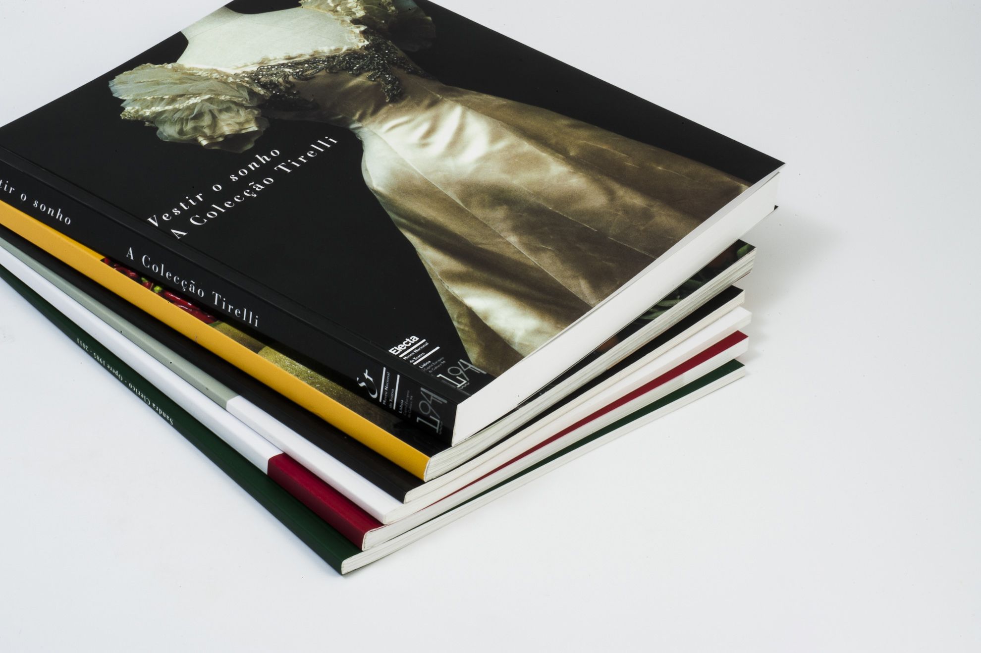 Professional perfect-bound catalogues and books with premium quality printing and binding. Stack displays multiple formats suitable for publishers, photographers, and businesses. Includes lamination and stitching finishing options for your custom print projects.
