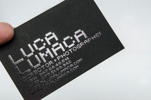 Sophisticated black paper business cards with striking silver hot foil stamped text that creates a premium, elegant impression. The matte black finish paired with metallic details delivers a modern look perfect for professional branding. Make a lasting impact with these high-quality, professionally printed cards that showcase your brand's sophistication and class.