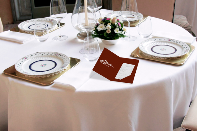 An elegant brown receipt holder displayed on a fine dining table, showcasing how customized details enhance restaurant sophistication. Personalized receipt holders like this one make a lasting impression on guests and reflect your business's commitment to quality. Custom printed receipt holders are an essential detail for distinguishing your restaurant and elevating the dining experience.