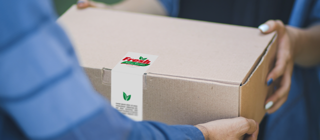 Bright multicolored square adhesive stickers applied on cardboard packaging demonstrate effective branding and product decoration. These personalized paper labels showcase how custom stickers enhance visibility and create professional marketing impact for branded products.
