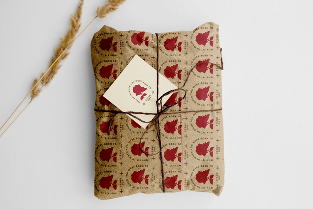 Custom kraft wrapping paper red strawberry pattern on gift package Gift package in kraft paper with red strawberry pattern and twine. Custom print rolls with logos Sprint24.