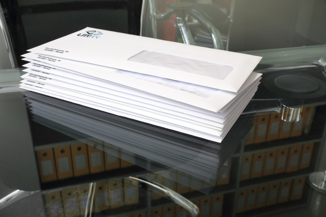 Stack of white envelopes featuring a rectangular window cutout for address visibility. Sprint24 offers full customisation with Pantone colour printing, embossing, and personalised design for professional business mail and postal campaigns.