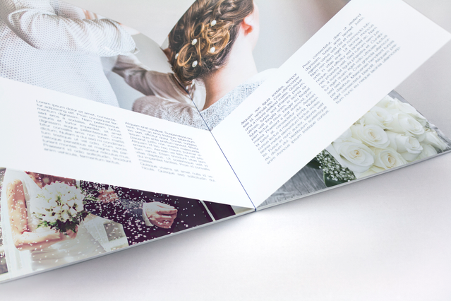 Open flat-bound paperback book displaying high-definition color photography with complete 180-degree panoramic opening. The flat binding eliminates gutters and allows full spread viewing for landscape and portfolio photography. Perfect for professional photobooks and travel albums with superior HD color reproduction.