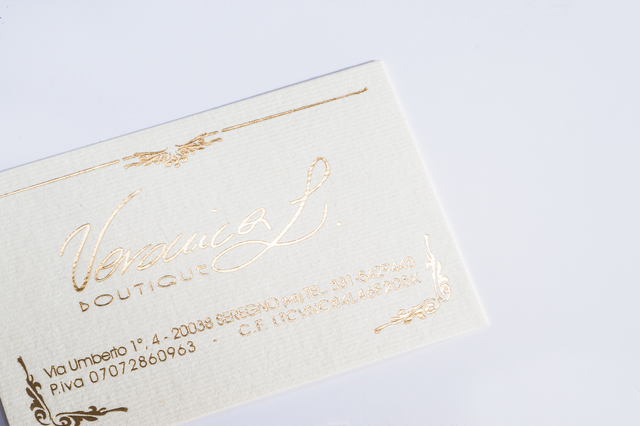 Premium business cards featuring gold hot foil stamping on acquerello ivory 300 gsm paper. The elegant design showcases metallic accents perfect for luxury branding and professional identity. These custom printed cards deliver distinctive visual impact with high-quality hot foil finishing.