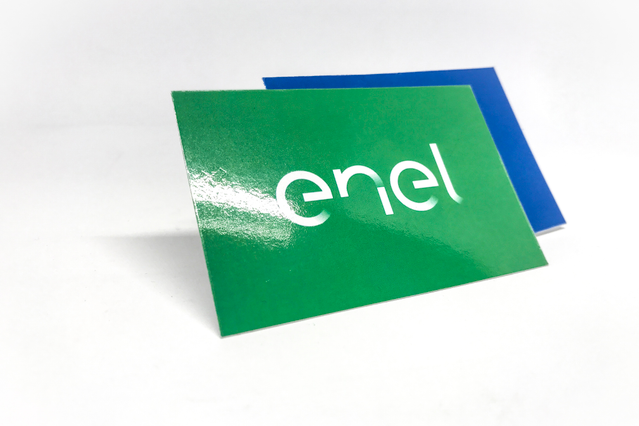 Professional laminated business cards displayed in vibrant green and blue with modern brand typography and white text design. The cards showcase a glossy, laminated finish that delivers premium quality and durability. Ideal example of Sprint24's online printing services for customized laminated business cards.