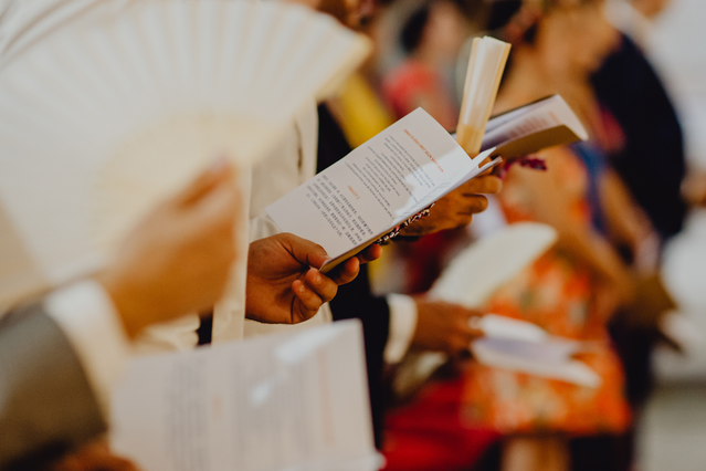 Professional wedding mass booklet held by ceremony guest, showcasing quality custom printing for special occasions. Sprint24 offers fully customizable wedding booklets with professional finishing and discounts up to 40%. Perfect for religious ceremonies, receptions, and formal events.