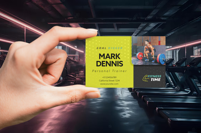 Hand holding bright yellow personal trainer business card in gym Personal trainer business card with striking yellow design displayed in modern gym. Sprint24.