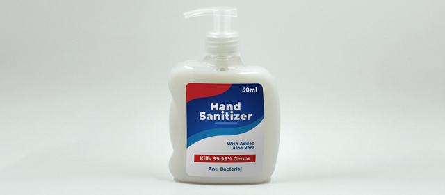A 50ml hand sanitizer pump bottle featuring a custom vinyl sticker label with bold red, blue and white design. The label clearly displays product name, aloe vera content, and antibacterial claims. Custom vinyl stickers from Sprint24 are durable, water-resistant, and ideal for product labeling on smooth surfaces.