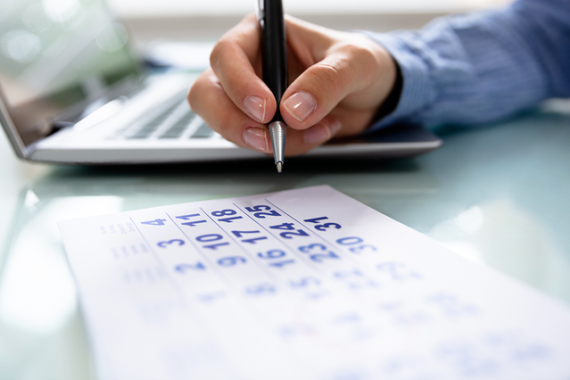 Hand writing in custom planner with blue pen Professional using a custom planner to organise tasks and schedules. Brand ambassador Sprint24.