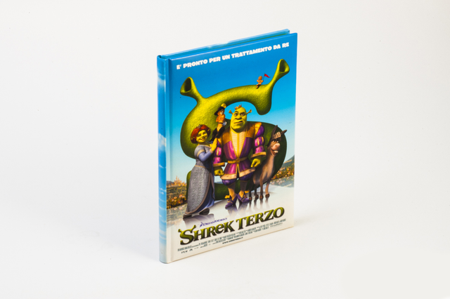 A hardback book with a full-colour illustrated cover of the animated film 'Shrek Terzo' featuring Shrek, Fiona, and Donkey characters on a white background. Hardback books with rigid sewn binding are the ideal format for children's books, illustrated volumes and publications that need to withstand heavy use — durable, premium and fully customisable.