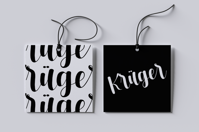 Two square clothing hang tags for the Kruger brand shown side by side: one white with bold black lettering and one solid black with white script logo. Both tags are threaded with black cord, showcasing customizable garment tags. Perfect example of personalized square clothing tags printed for fashion brands.