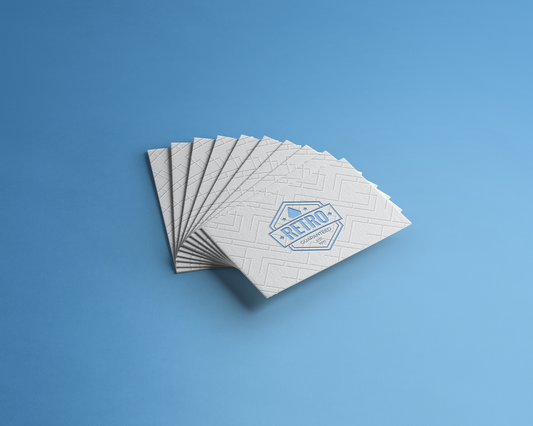 Premium white letterpress cards showcasing elegant geometric embossed design with dry debossing technique on 600gr cotton paper. The blind embossing creates sophisticated tactile relief that conveys absolute elegance and refinement. Ideal for upscale business cards combining visual and tactile luxury.