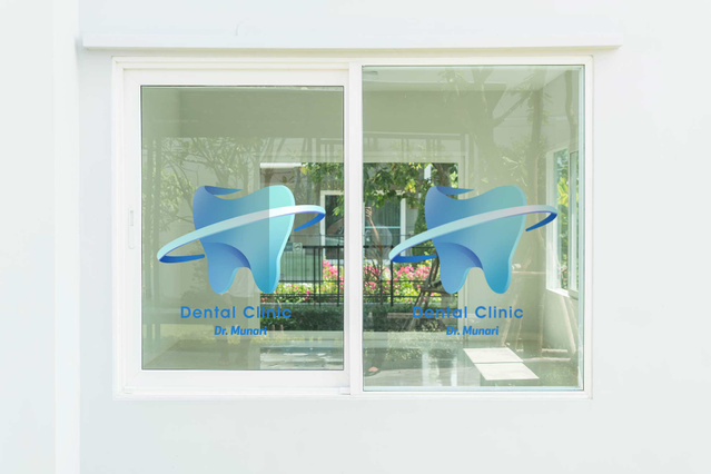 Professional dental clinic branding featuring a pre-spaced transparent blue logo with text, applied as a durable PVC adhesive sticker on glass windows. This pre-spaced design is ready to apply with covering glue, ensuring perfect alignment and professional visibility for storefronts and office signage.
