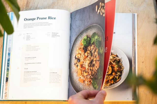 Professional cookbook layout featuring detailed recipe instructions alongside vibrant food photography of Orange Prime Rice. This example demonstrates the quality and design of printed cookbooks that can be customized with your own recipes and signature dishes. Perfect for creating personalized cookbook printing projects with professional presentation and food styling.