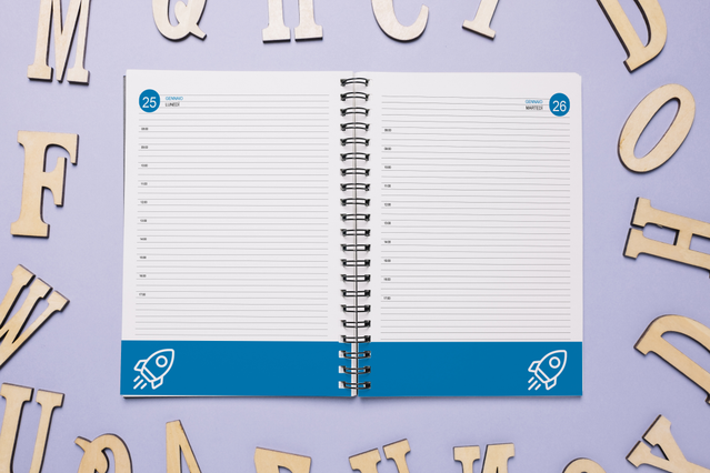 Open spiral daily agenda with blue rocket banner and lined hourly sections. 336 pages educational Sprint24.