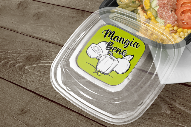 A branded circular sticker applied to a clear food packaging container, showcasing professional box sticker personalization. Custom labels enhance product presentation and establish brand identity for food businesses, ideal for takeout packaging and retail solutions.