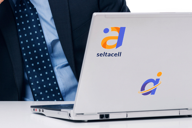 A custom 'Seltacell' company logo applied as a pre-spaced vinyl decal on a silver laptop lid, with a businessman in a suit working in the background. Sprint24 prints custom pre-spaced vinyl decals for laptops, devices and office branding — perfect for corporate identity, employee gadgets and promotional gifting with up to 60 months durability.