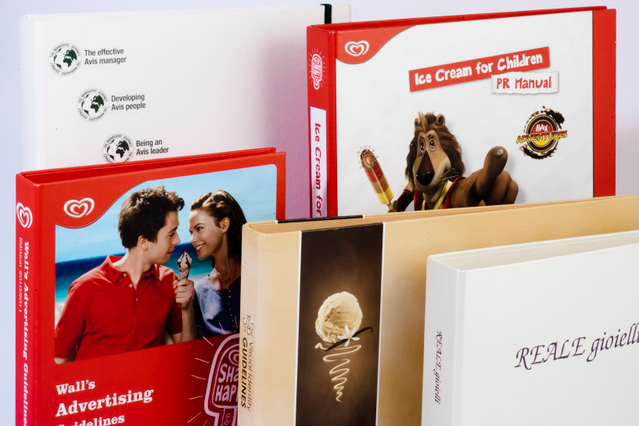 Stack branded ring binders ice cream marketing and jewellery brands Stack of branded ring binders: Wall's, Ice Cream PR Manual, REALE gioielli. Corporate communications Sprint24.
