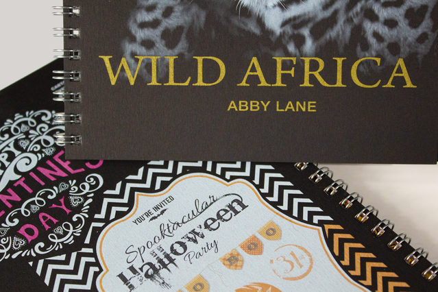 Three spiral notebooks Wild Africa gold foil Valentine UV and. Three notebooks showing premium finishes: Wild Africa gold foil, Valentine UV varnish and Halloween print. Sprint24.