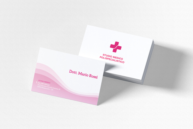 Two custom white medical business cards with a soft pink wave graphic — one showing 'Dott. Mario Rossi' contact details, the other displaying a pink medical cross and 'Studio Medico Polispecialistico' branding. Custom-printed business cards for doctors, medical clinics and specialists project a professional image and make it easy for patients to keep your contact details to hand.