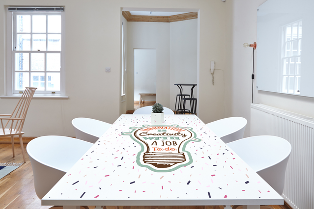 Custom white adhesive PVC graphic professionally applied to a flat wooden floor, demonstrating bubble-free adhesion and precise shape cutting. The high-gloss white opaque finish showcases Sprint24's superior quality for personalized large format prints on flat surfaces. Perfect for creating branded graphics, floor stickers, and shaped adhesive applications with exceptional abrasion resistance.