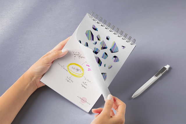 This professional metal spiral-bound notebook features durable white pages fully customizable with your branded design. The image showcases a sample layout with abstract patterns and company branding elements. Perfect for corporate gifts, office supplies, and personalized branded notebooks for meetings and business use.