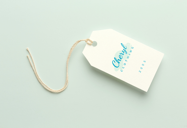 This white shaped clothing tag demonstrates custom branding for fashion labels and boutiques. The tag's distinctive shape and blue printed design exemplify how personalization creates memorable brand identities on garments. The attached string ensures easy application to finished products, making it ideal for entering the fashion market with professional presentation.